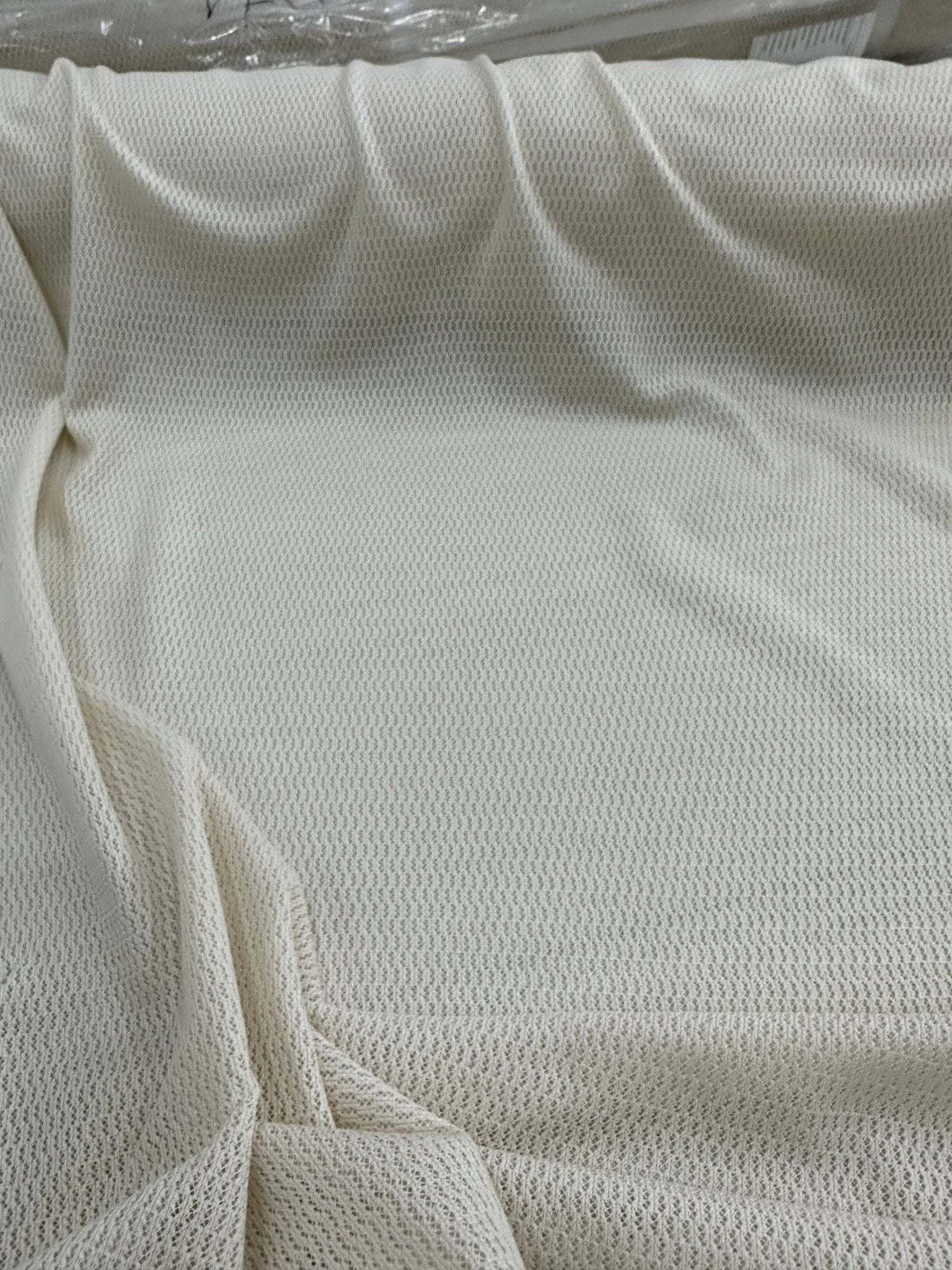 100 cotton off-white fishnet mesh fabric suitable for crafting and apparel projects with breathable open weave texture