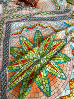 Greek mosaic print silky crepe fabric with vibrant geometric mosaic pattern in green, orange, and blue tones.