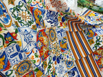 Colorful Sicilian print silky crepe fabric with intricate Mediterranean tile patterns and vibrant floral and striped designs