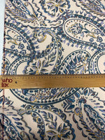 Cream background fabric with blue and yellow paisley print and measuring ruler showing scale