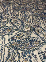 Cream background fabric with intricate blue and beige paisley print design