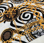 Gold Chain Greek Key patterned white crepe fabric with gold chain and black decorative motifs