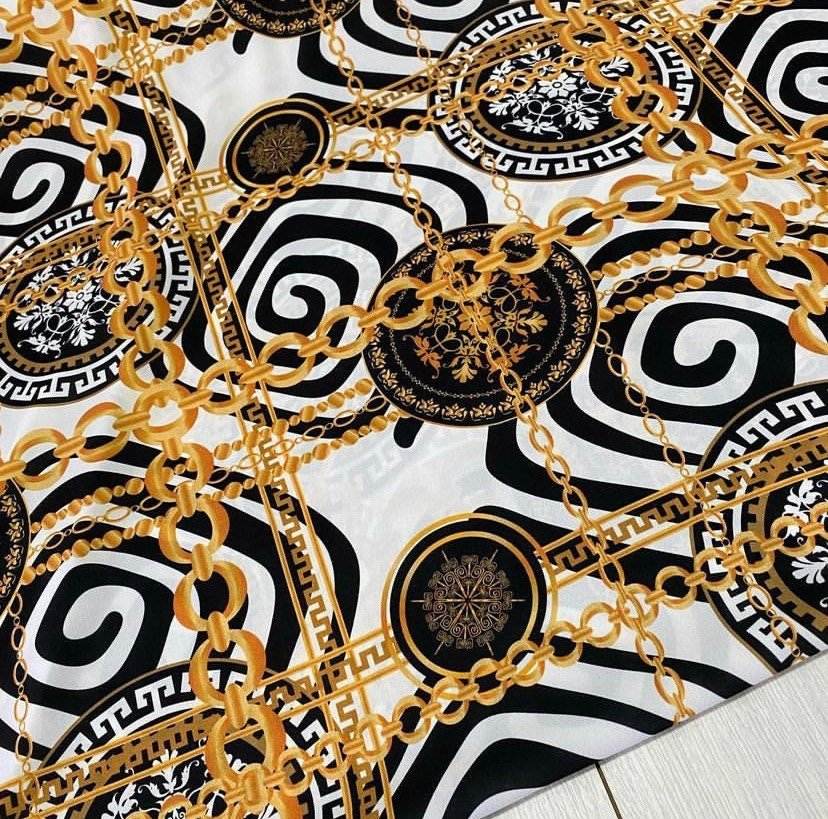 Gold Chain Greek Key patterned crepe fabric with white, black, and gold chain design