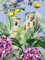 Tropical parrot print crepe fabric with vibrant parrots, tropical leaves, flowers, and architectural elements on a light blue background