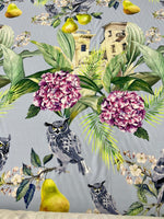 Tropical Parrot print crepe fabric with vibrant parrots, green leaves, and flowers on a gray background