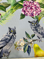 Tropical parrot print crepe fabric with vibrant floral and owl design on soft textured textile