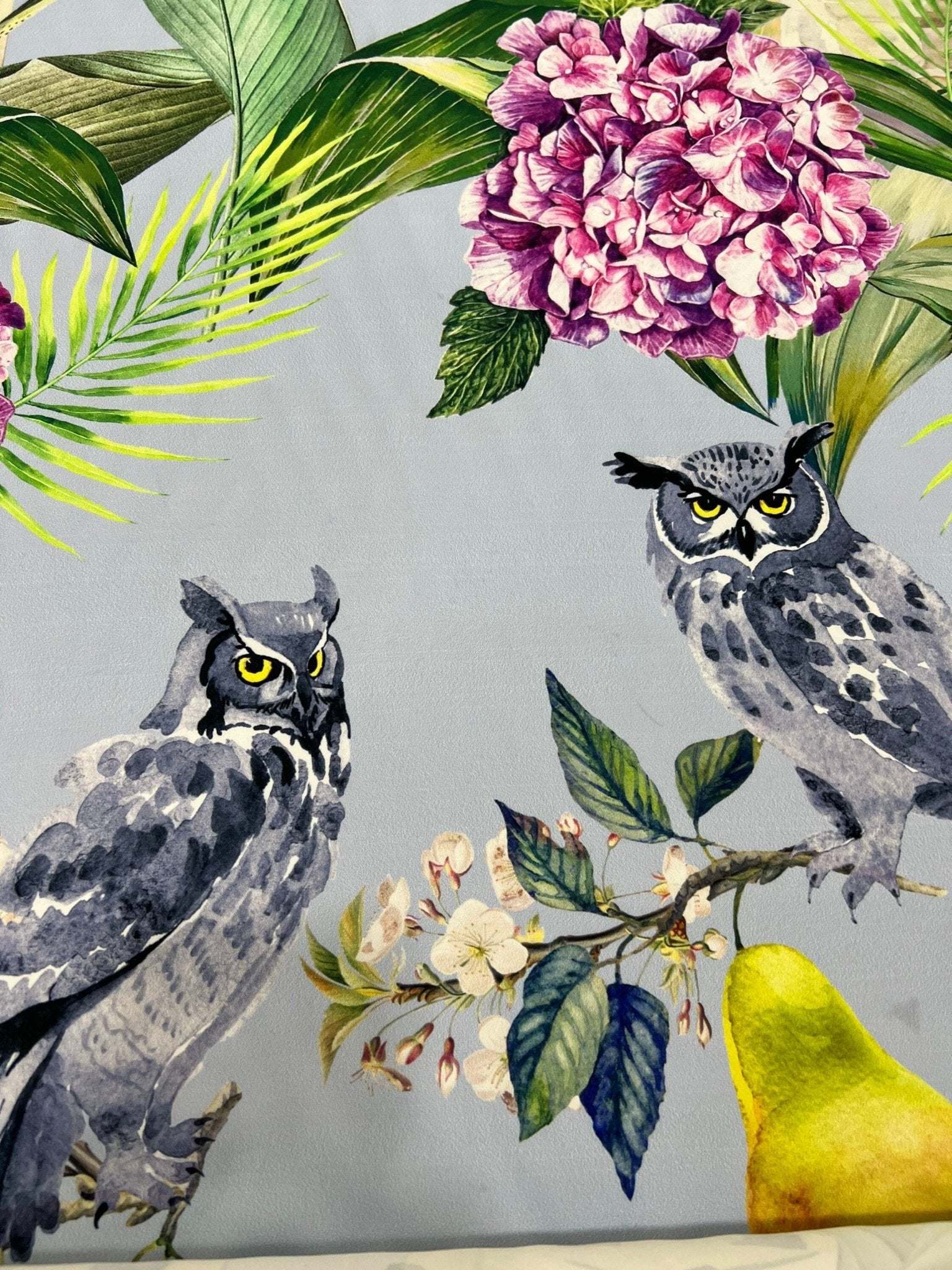 Tropical parrot print crepe fabric with vibrant floral and owl design on soft textured textile