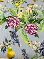 Tropical parrot print crepe fabric with colorful birds, purple flowers, green leaves, and yellow pears on a gray background