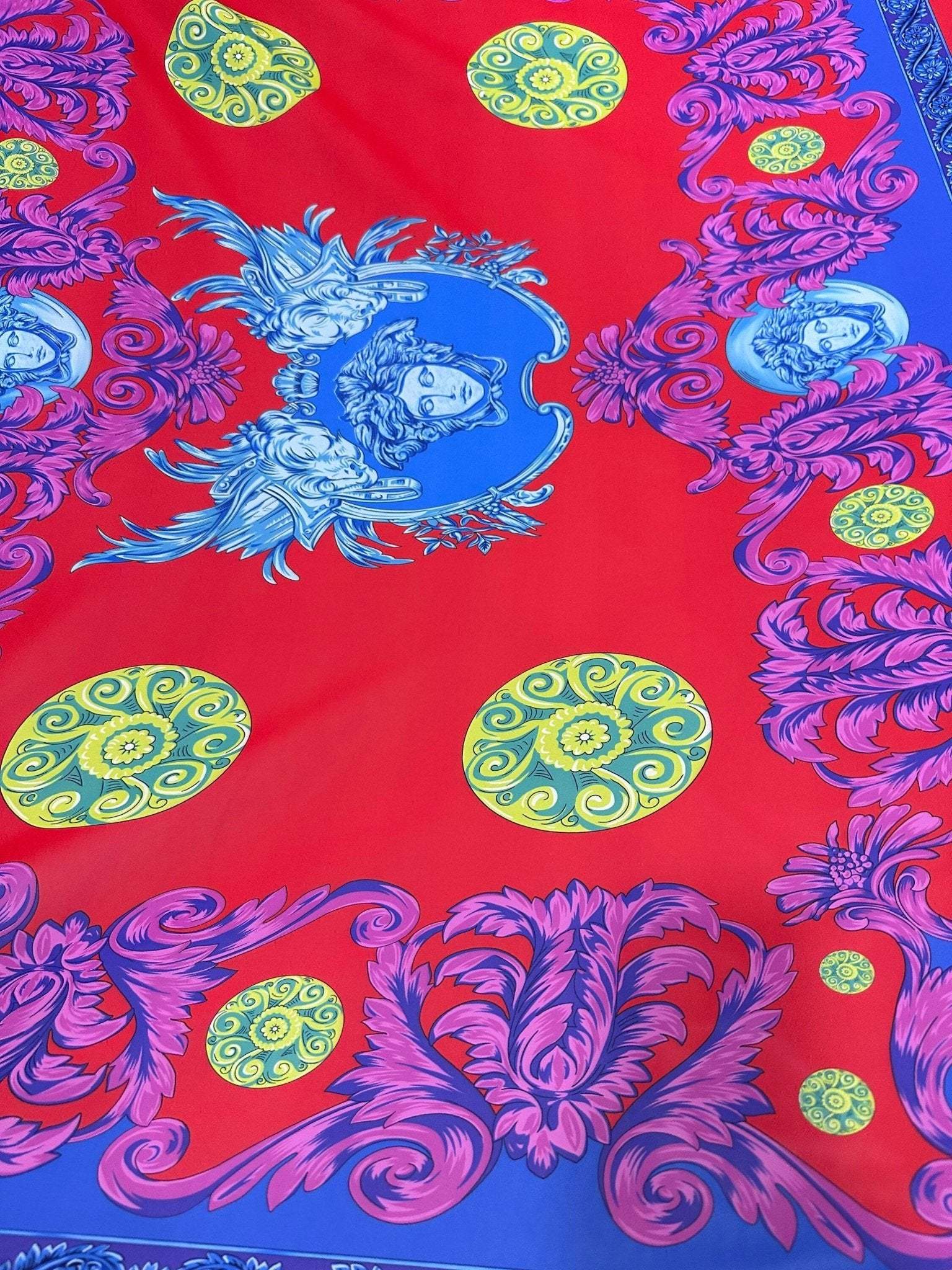 Purple swirl crepe fabric with intricate blue and yellow pattern on red background