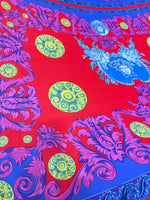 Purple Swirl Crepe Fabric with vibrant purple swirl designs on a red and blue background with yellow circular patterns, fabric width 150cm.