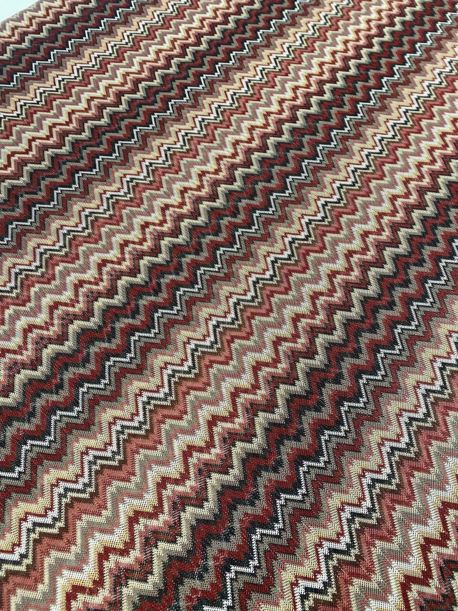 earth tone zigzag woven mesh fabric with green, brown, and beige knit pattern for versatile sewing projects