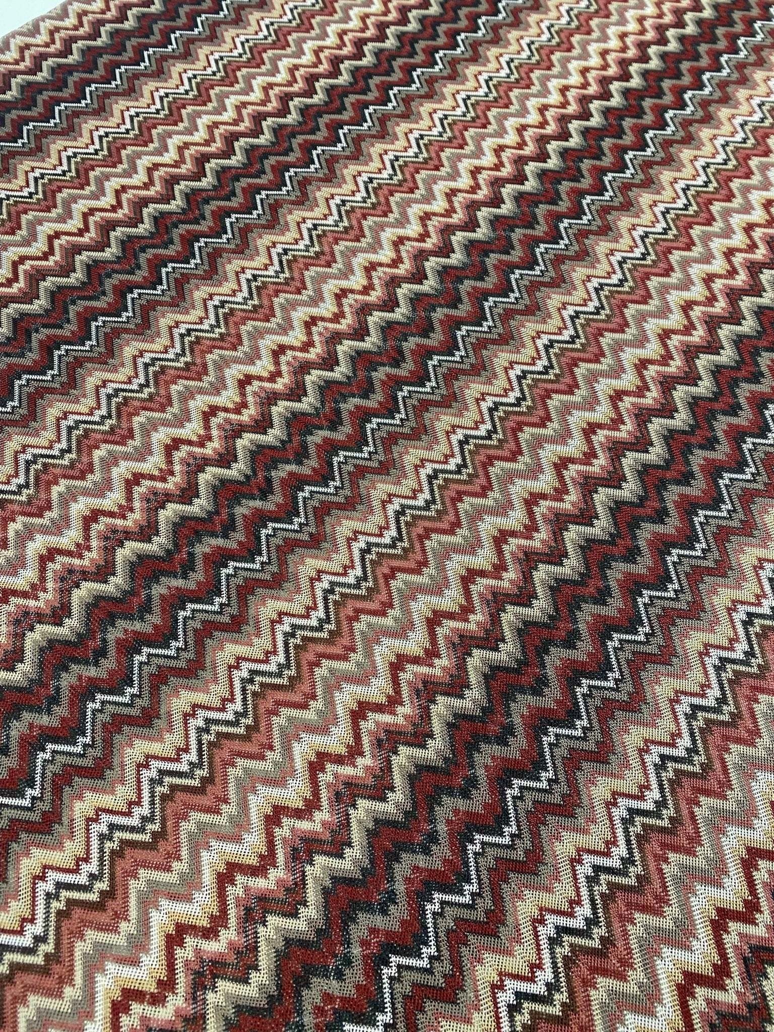 earth tone zigzag woven mesh fabric with green, brown, and beige knit pattern for versatile sewing projects