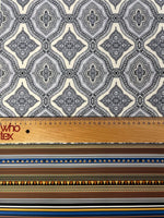 Black and white mandala pattern fabric with ethnic geometric striped border and measuring ruler for scale