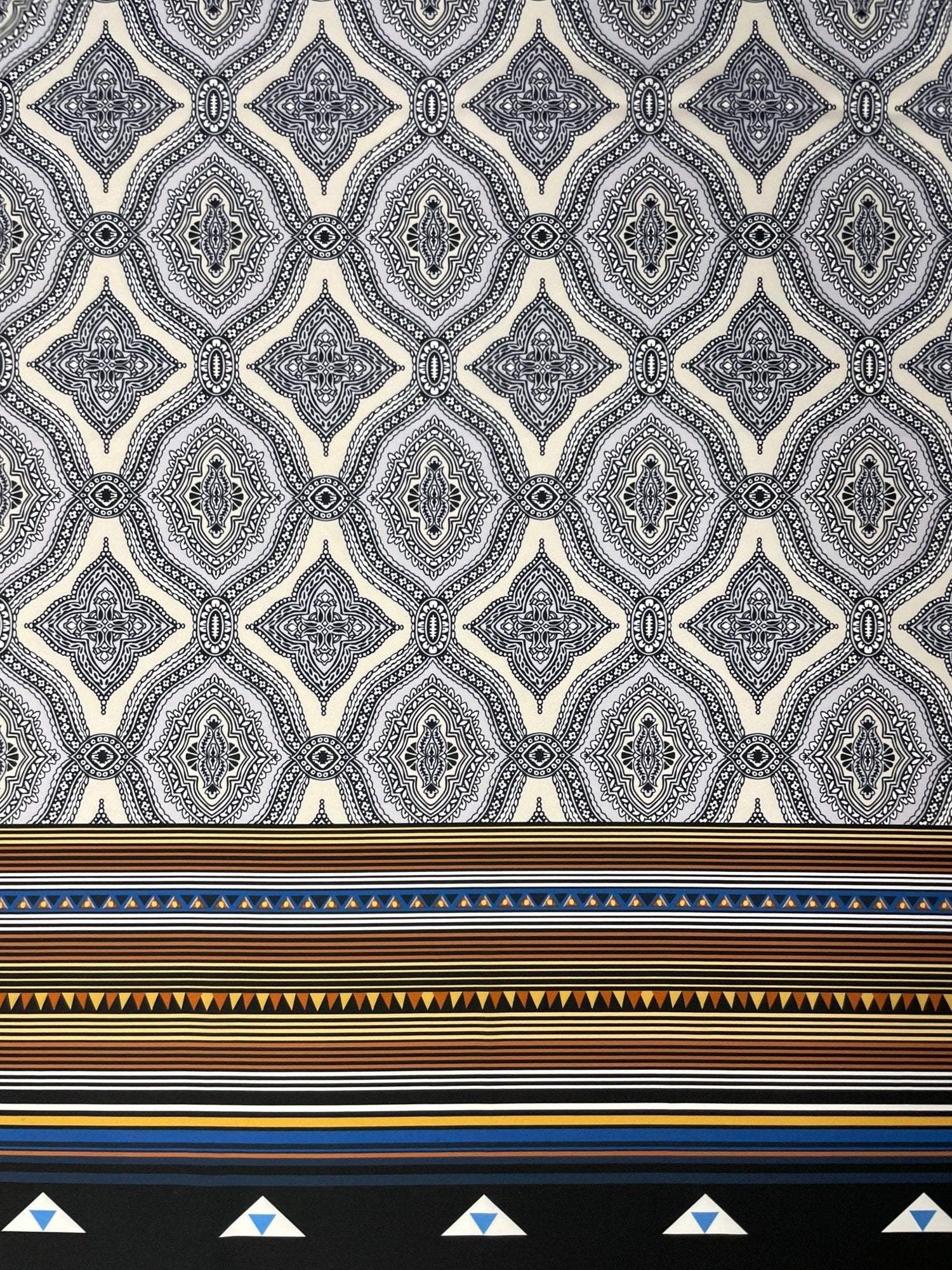 Black and white mandala pattern fabric with ethnic geometric striped border and tribal design elements