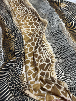 Exotic animal print fabric with giraffe, zebra, and leopard patterns in neutral tones