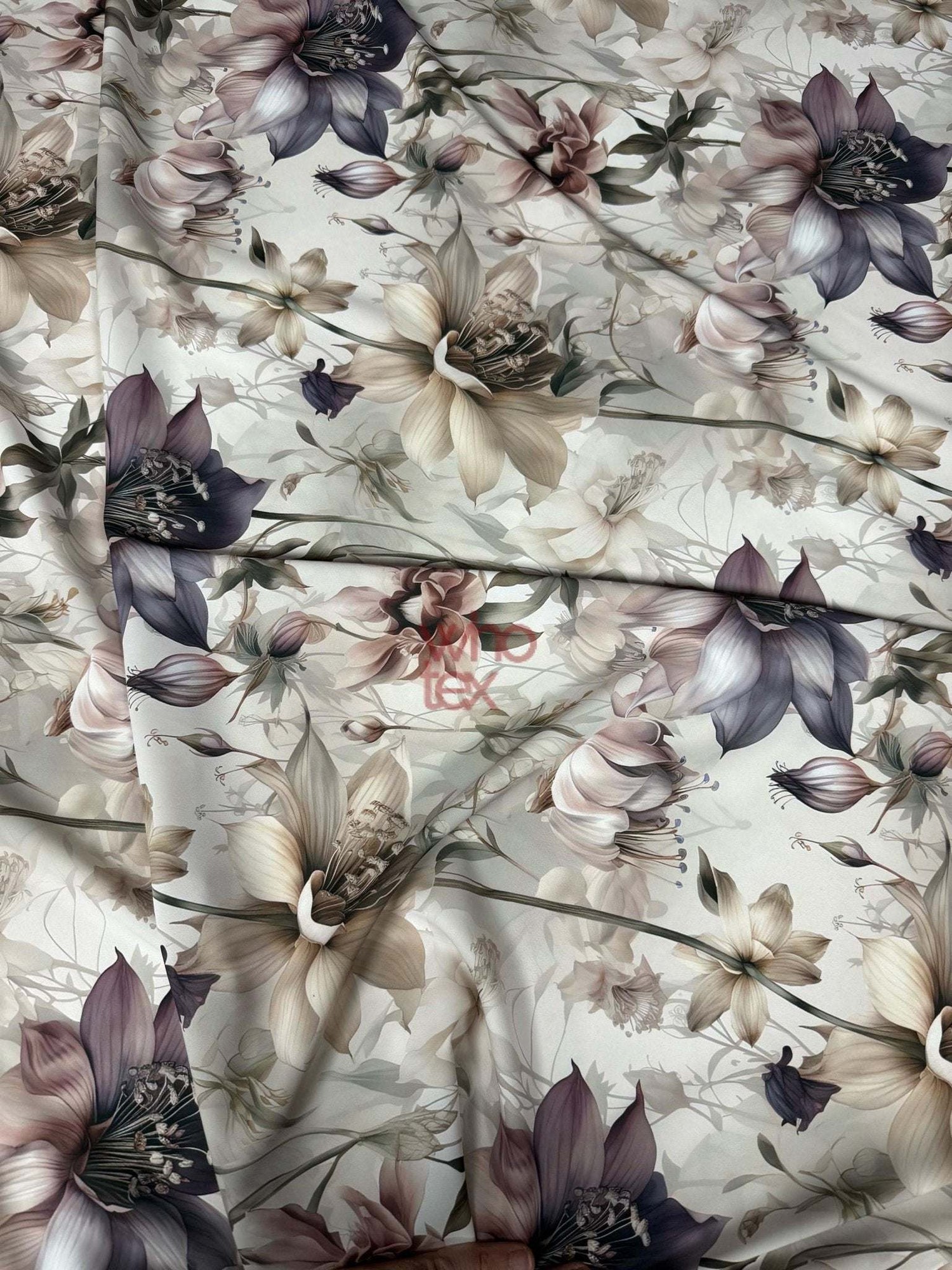 Vintage botanical print fabric with soft satin texture featuring muted floral designs in beige, purple, and brown tones.
