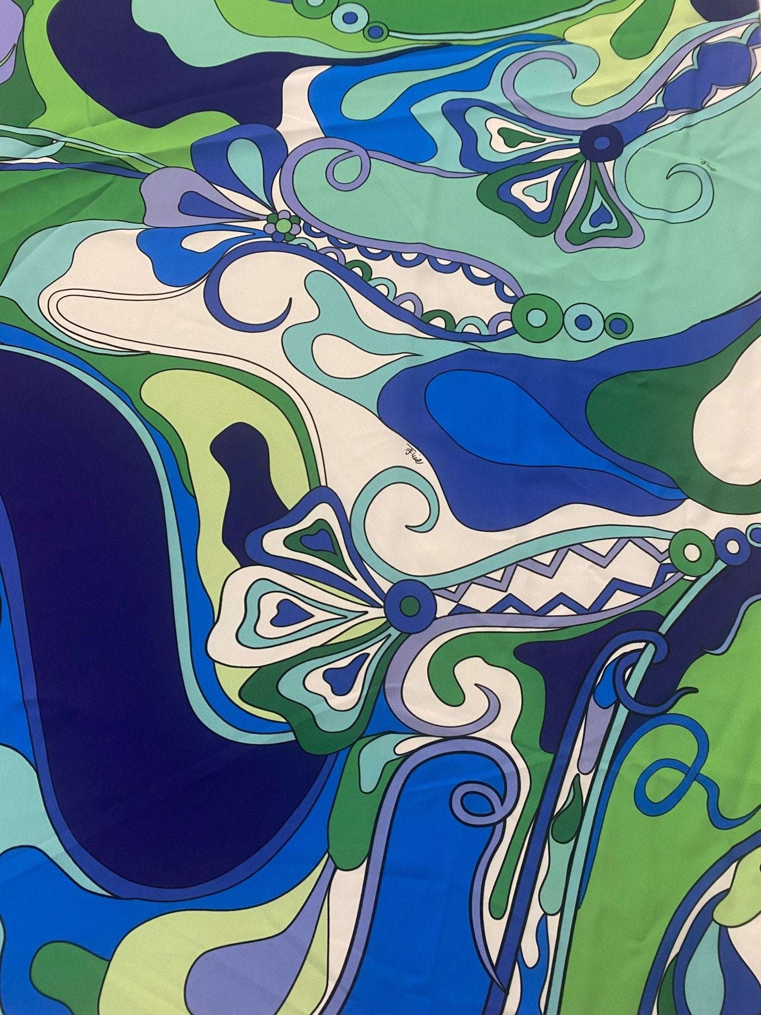 Blue and green floral fabric with retro swirl print in vibrant colors