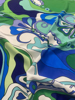 Blue and green floral fabric with retro swirl print and soft texture