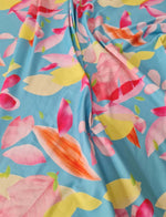 Soft cotton floral print fabric with colorful petals on blue background