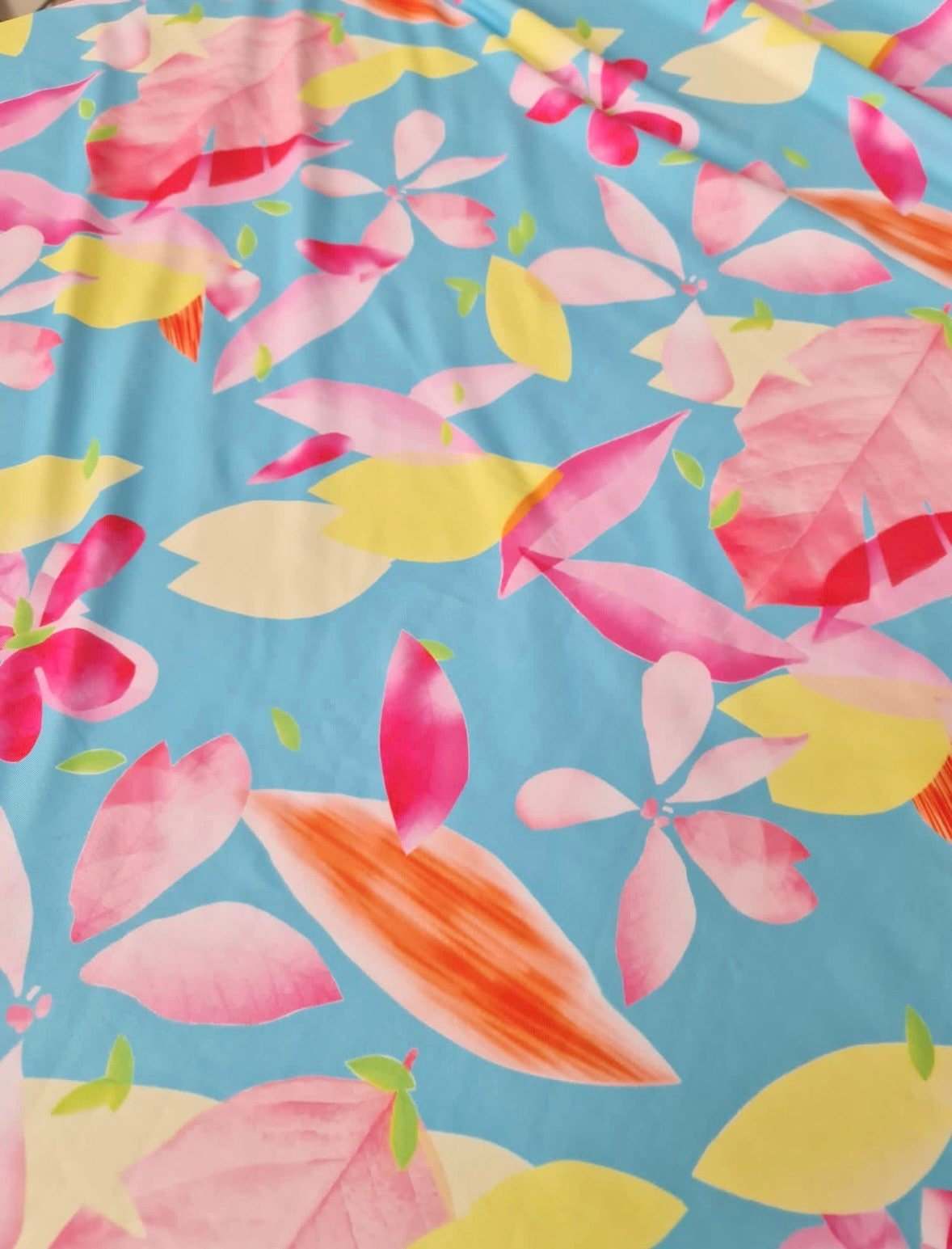 Soft cotton floral print fabric with pink, yellow, and orange flowers on blue background, 150cm wide