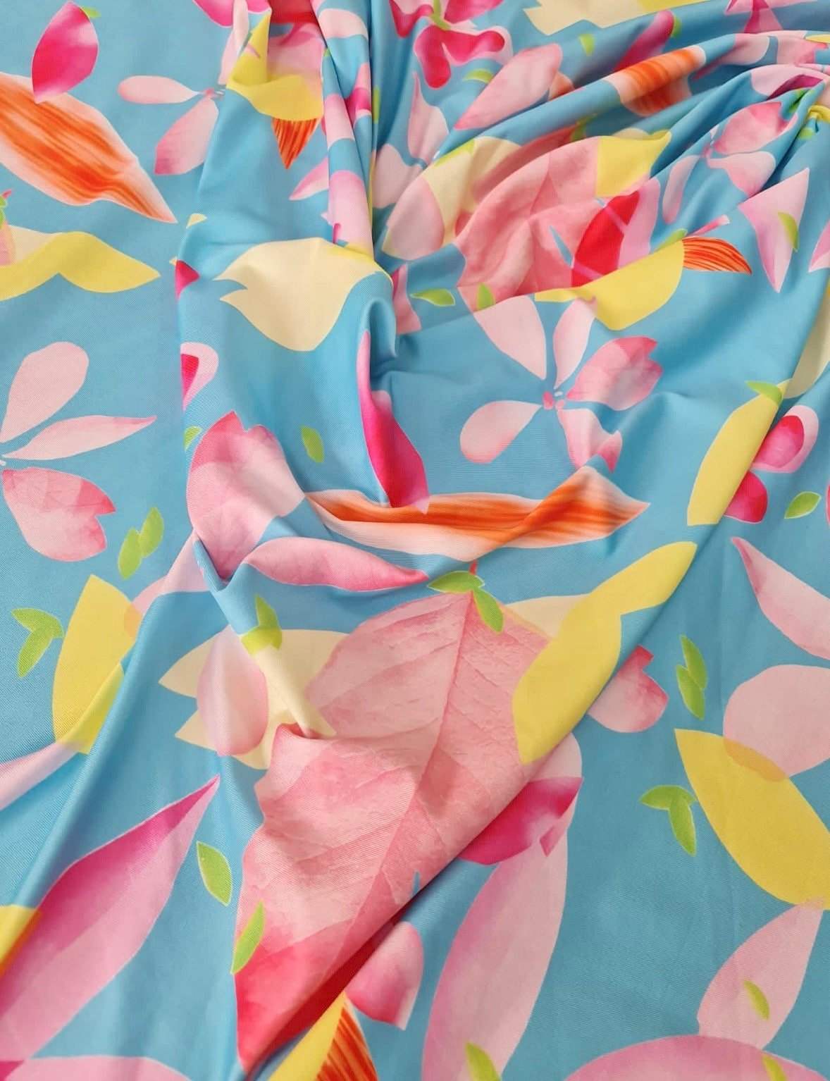 Soft cotton floral print fabric with pastel flowers on blue background