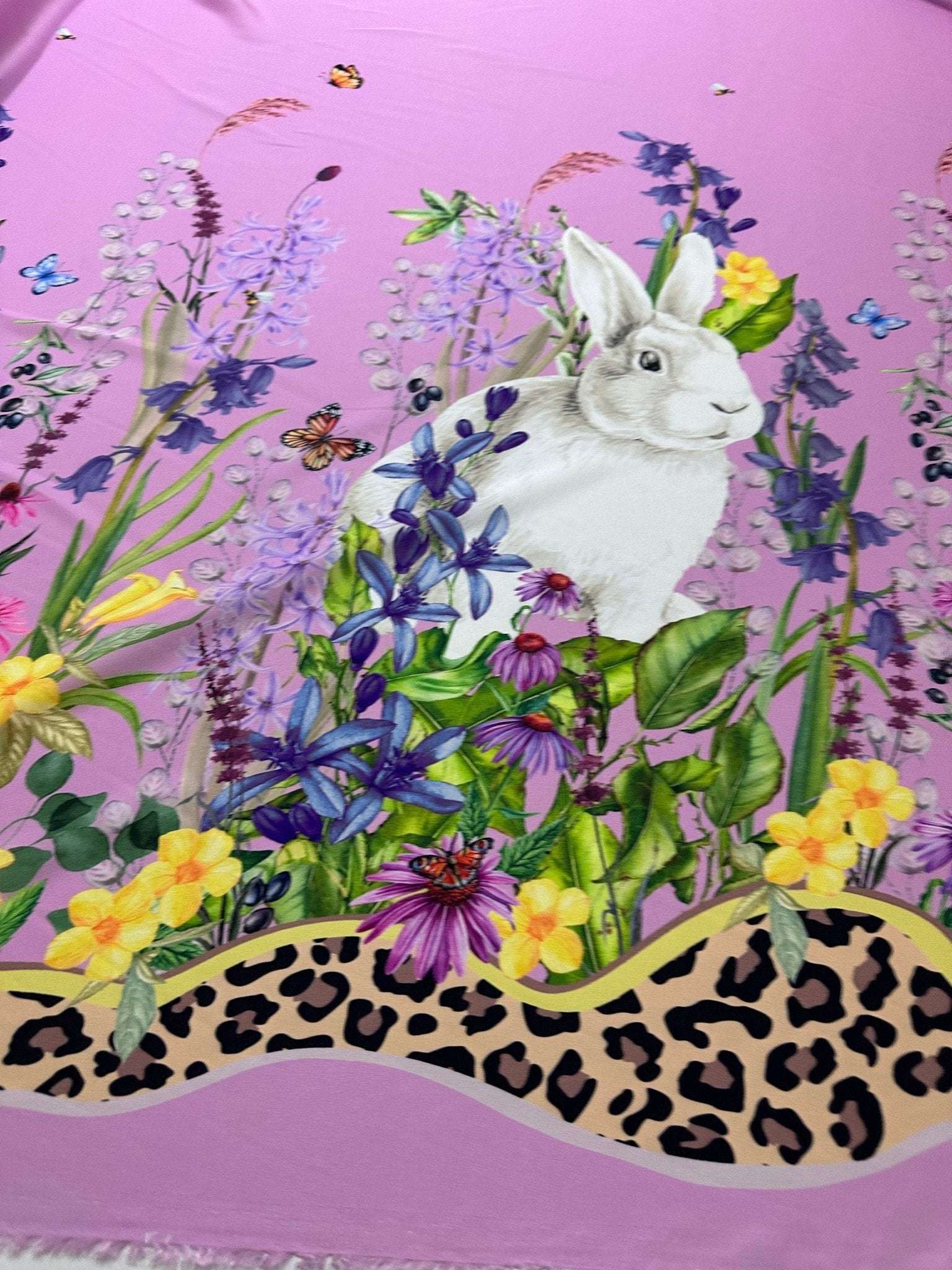 Pink fabric with rabbit print and colorful floral pattern
