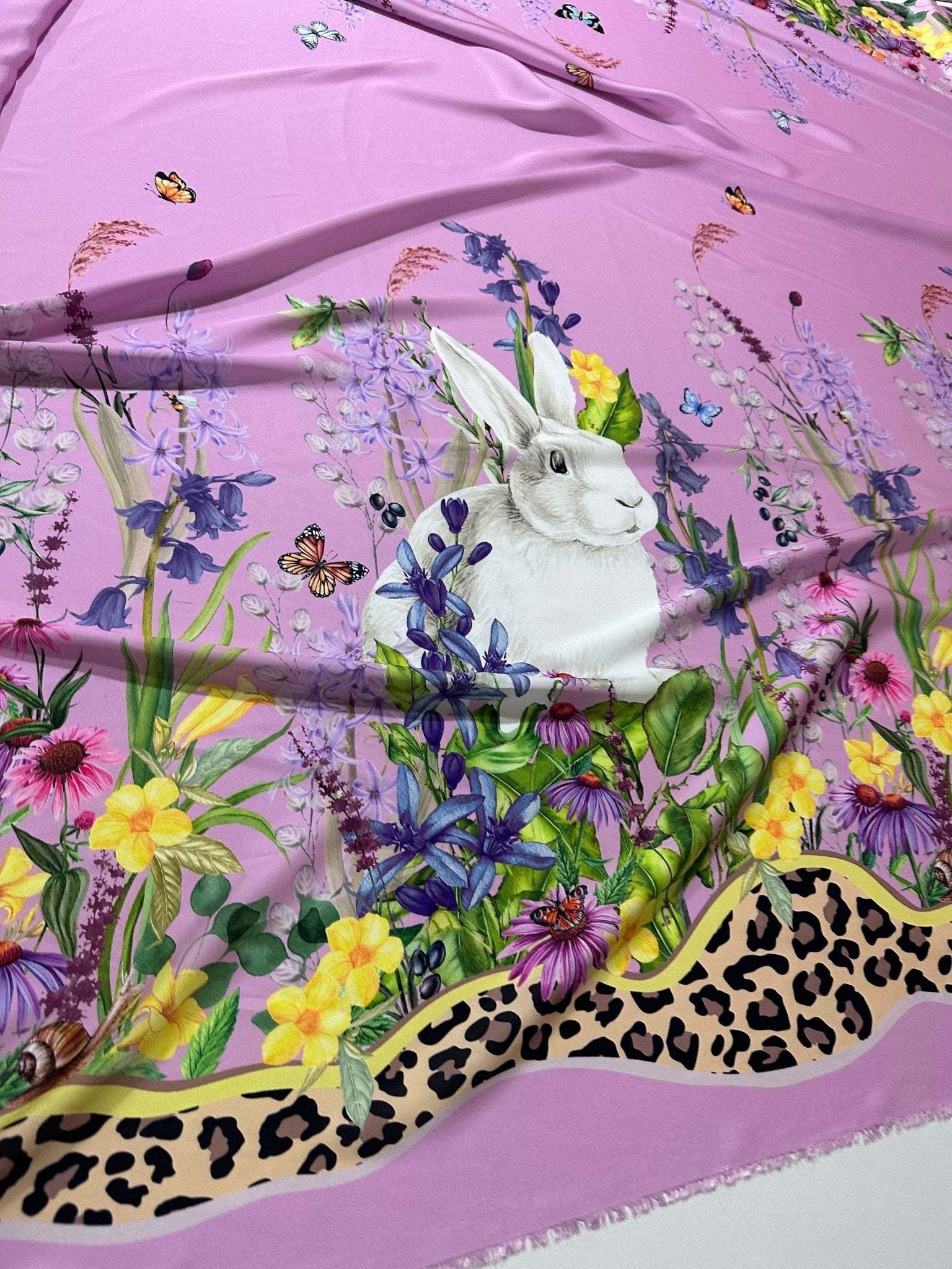 Pink rabbit print fabric with colorful flowers and leopard print border