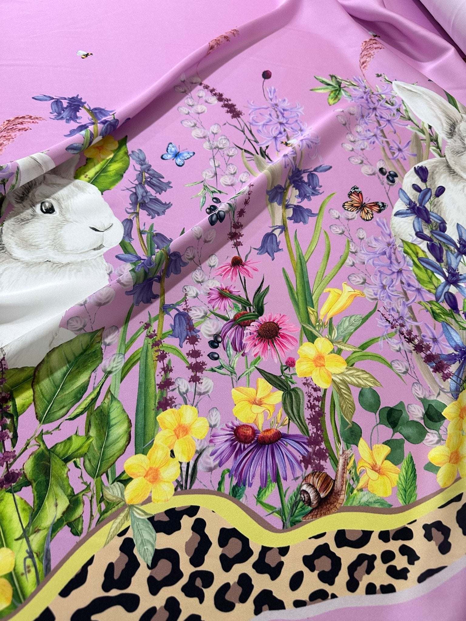 Pink rabbit print fabric with colorful flowers and leopard border pattern