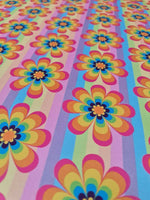 colorful rainbow floral fabric with vibrant flower patterns and striped background