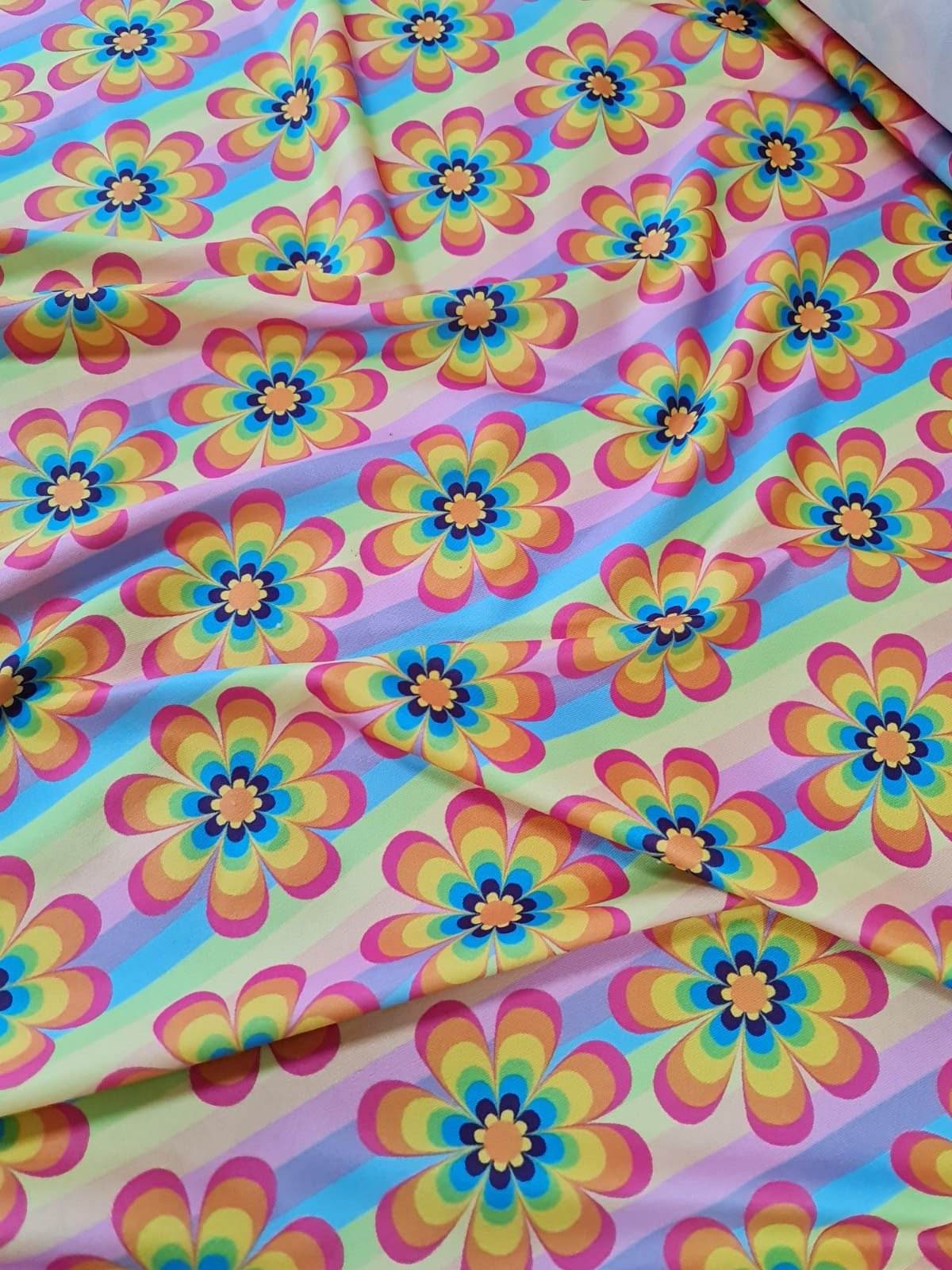 Rainbow floral fabric with colorful flower patterns on a vibrant background, ideal for sewing projects