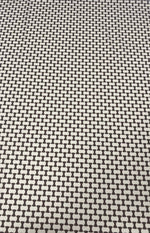 Close-up of geometric black and white optical illusion fabric with repeating shapes and high-quality texture