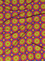 Bright colorful geometric circles print fabric with vibrant concentric ring patterns in yellow, green, blue, and red on a pink background.