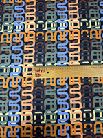 Geometric retro chain link pattern fabric in pastel tones with ruler for scale