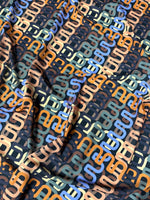 Geometric retro chain link pattern fabric with multicolor interlocking design on soft durable material