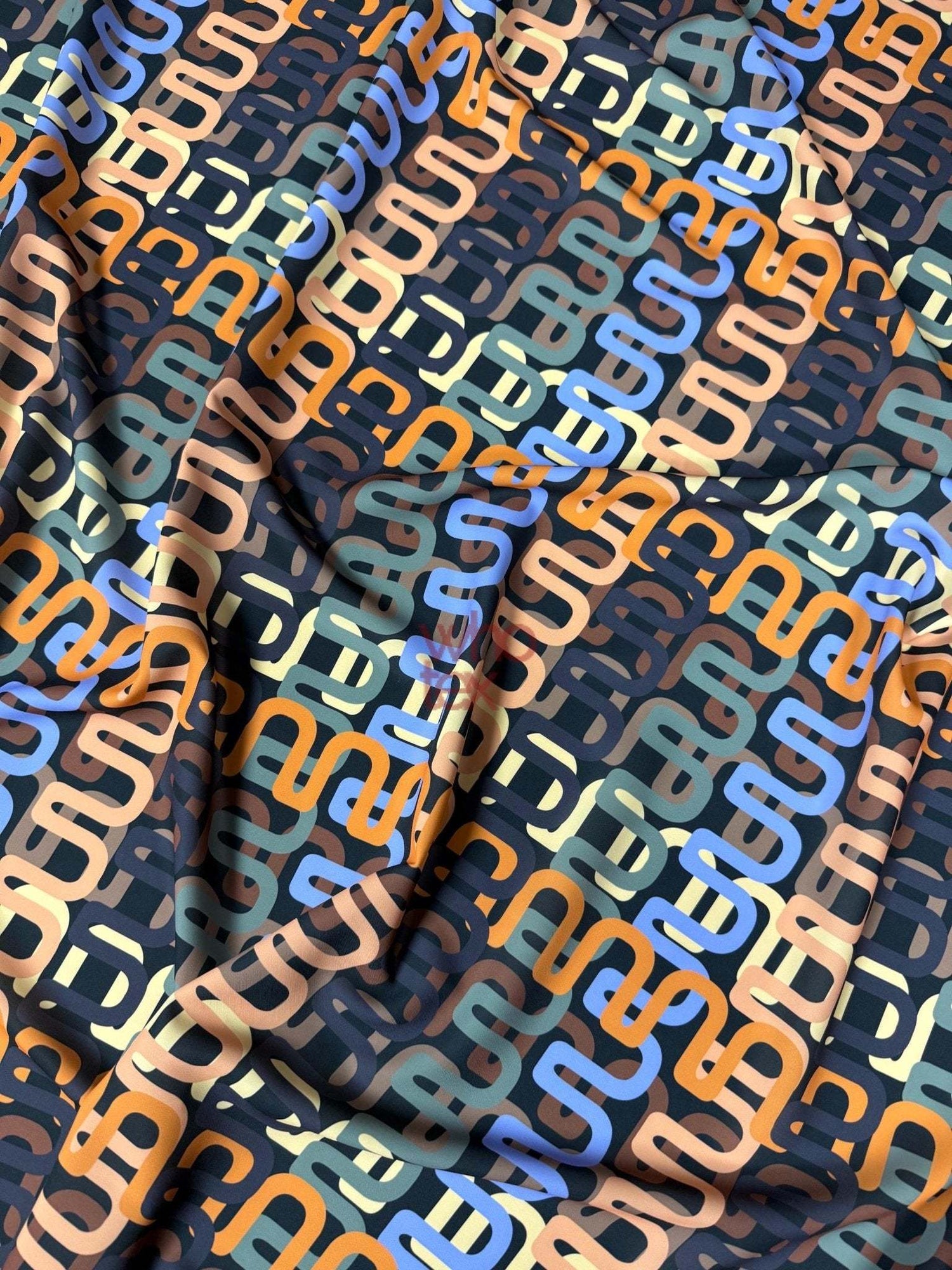 Geometric retro chain link pattern fabric with multicolor interlocking design on soft durable material