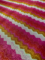 Gold Lurex pink zigzag knit fabric with glittery stretch texture and vibrant gold and pink stripes