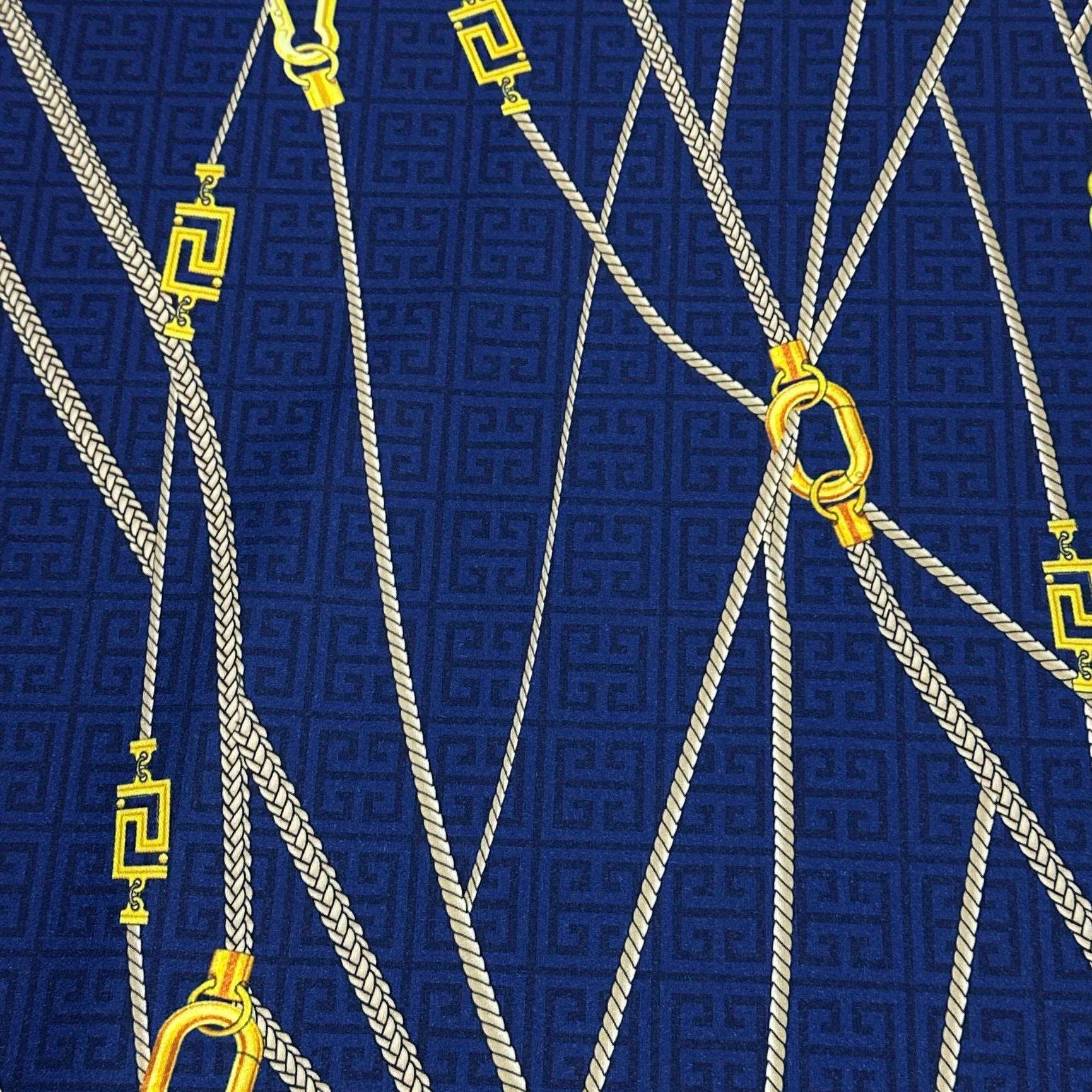 Navy blue Greek Key Pattern Fabric with white ropes and yellow gold clasps upholstery material