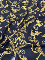 Black fabric with gold Greek key and ornate pattern design textile