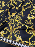 Black gold Greek key patterned fabric with ornate baroque design on black background and Greek key border