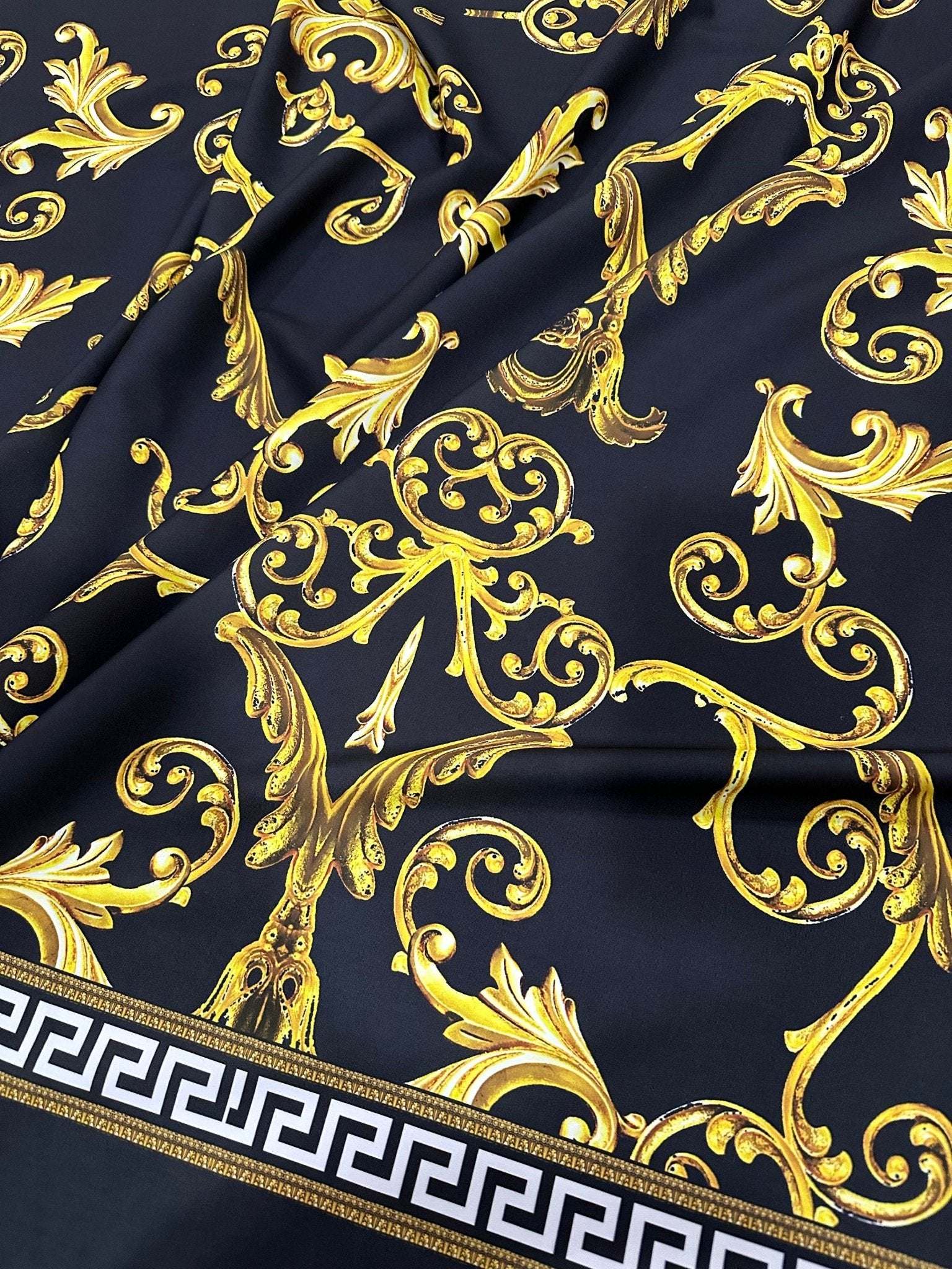 Black gold Greek key patterned fabric with ornate baroque design on black background and Greek key border