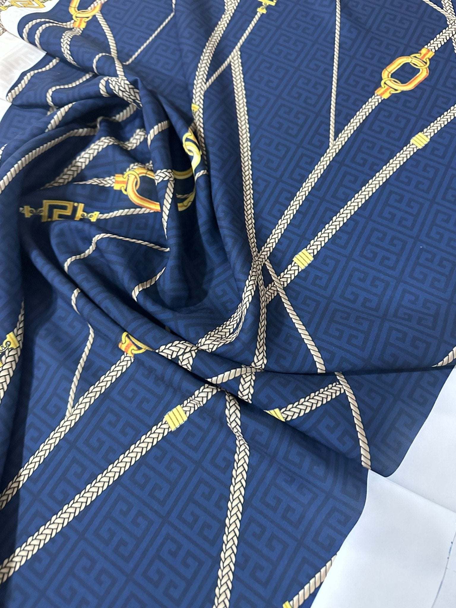 Navy blue fabric with Greek key pattern and gold chain design