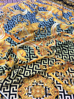 Gold Baroque Greek key pattern fabric in silky crepe with intricate gold and black design