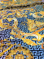 Silky crepe fabric with gold Baroque Greek key pattern and ornate design details on black background
