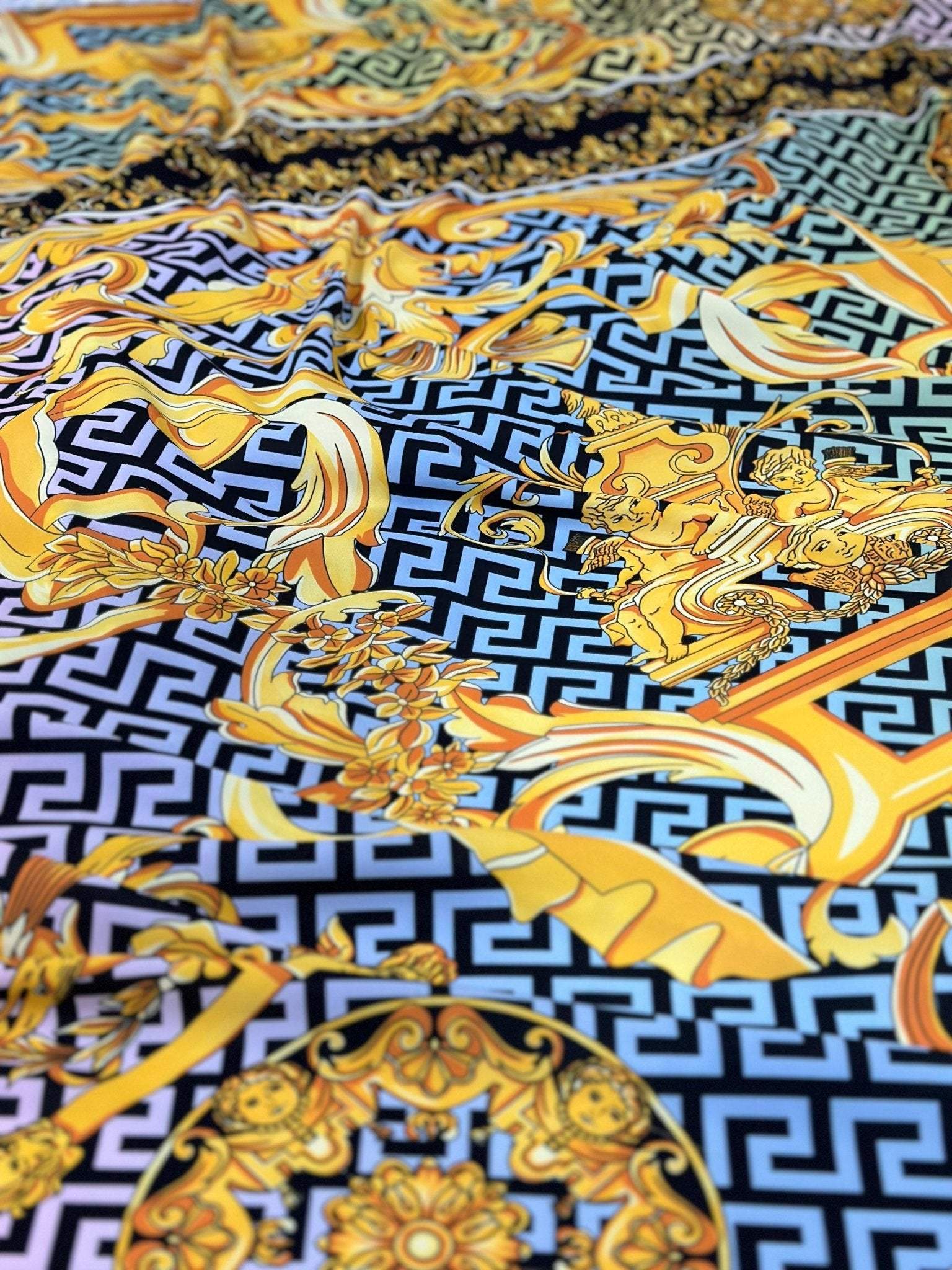 Silky crepe fabric with gold Baroque Greek key pattern and ornate design details on black background