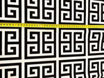 Greek Key Print Upholstery Fabric with black and white geometric pattern and measuring tape showing scale