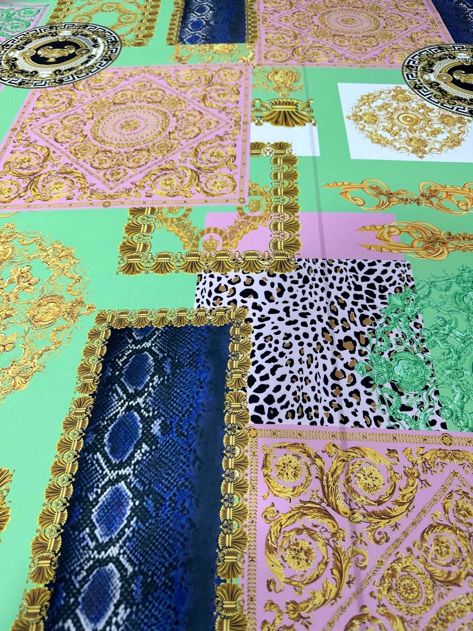 Green Baroque crepe fabric with floral and ornate patterns in green, pink, blue, and gold