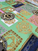 Green Baroque Crepe Fabric with ornate gold and floral patterns on green background