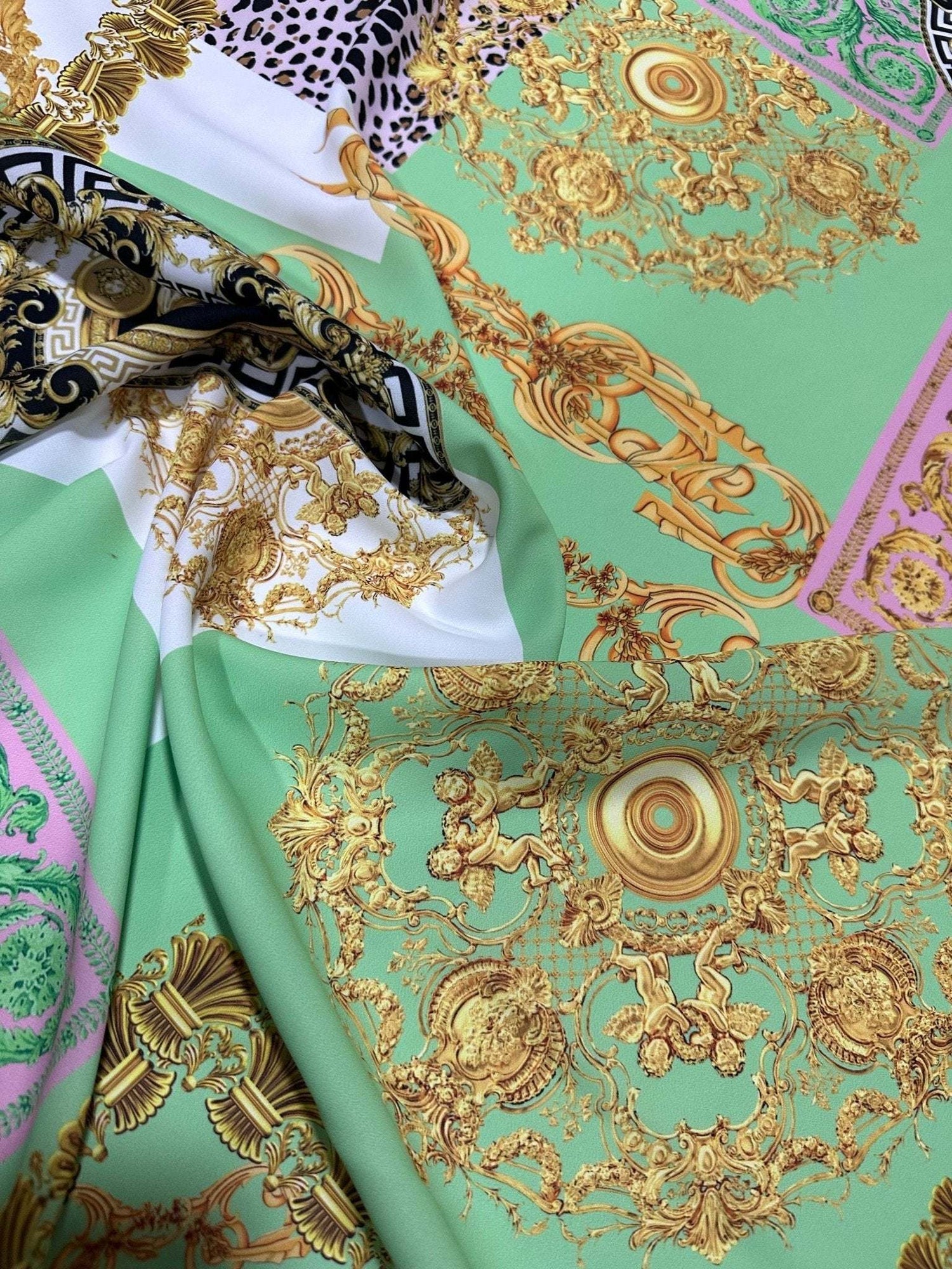Green Baroque Crepe Fabric with elegant gold floral baroque patterns on a green background, perfect for stylish sewing projects