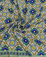 Sicilian pattern green fabric with blue and yellow floral motifs on a white background, 150cm wide textile for sewing and upholstery.