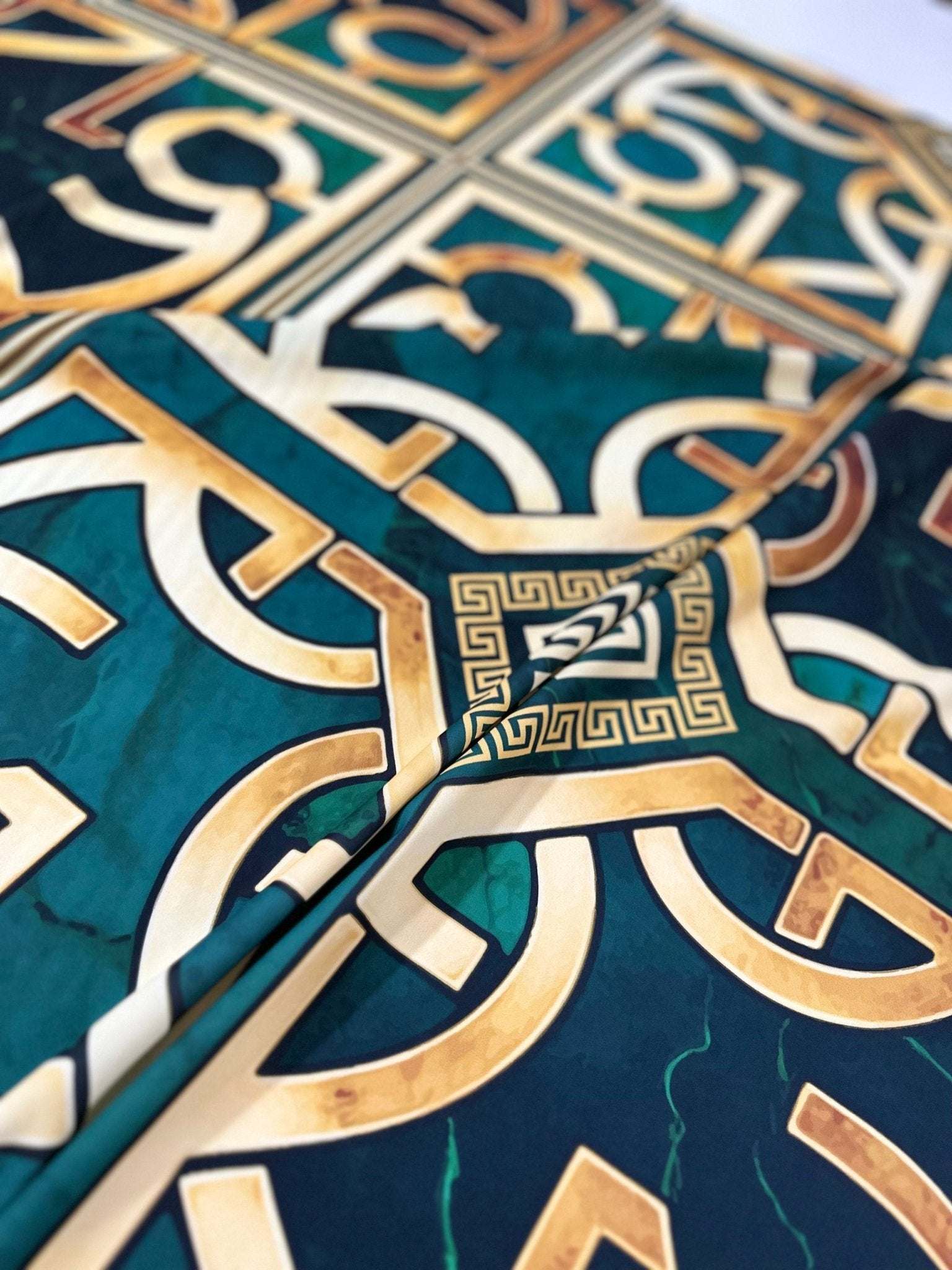 green gold crepe silky fabric with Greek key pattern and smooth texture